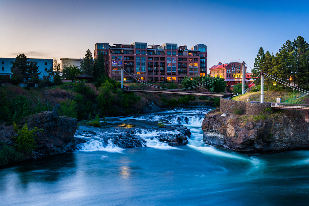 Twilight view of Spokane Falls, apartment building and Flour Mill in Spokane, Washington