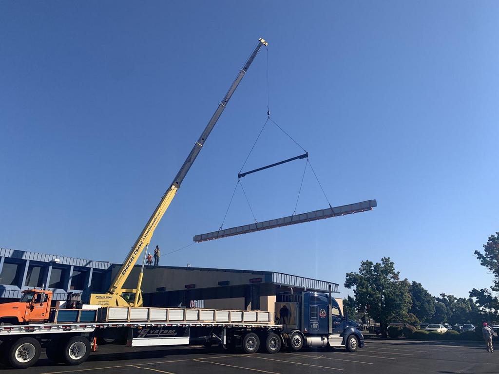 Truck-Mounted, Extension Crane Lifting Bundles Of 70-Foot Long Metal Roof Panels