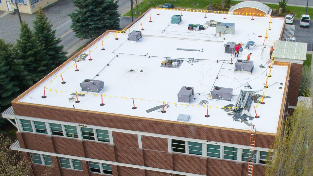 Commercial Flat Roof Replacement Crew Working Safely And Efficiently - Aerial View